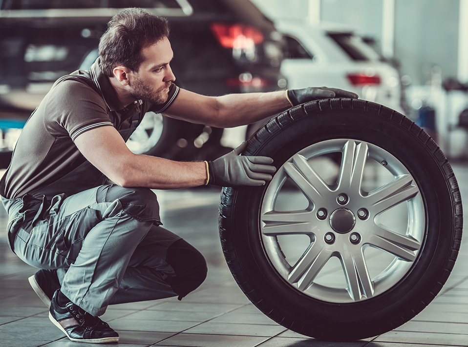 Mechanic checking over a tyre - Tyres Slough